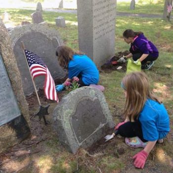Kids from First Parish Plymouth cleaning Burial Hill